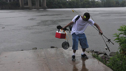 After two hours of fishing in the rain Sunday, Orlando Robinson of the Hill District decided to go home. Mr. Robinson said when he saw the Pedal Pittsburgh cyclists rolling through the rain, he decided if they could be out, so could he.