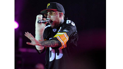 Mac Miller, in a cast from breaking his arm, returns to Pittsburgh and performs at First Niagara Pavilion with fellow Pittsburgh rap artist Wiz Khalifa.