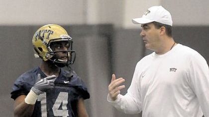 New Pitt head football coach Paul Chryst works with wide receiver Ronald Jones.