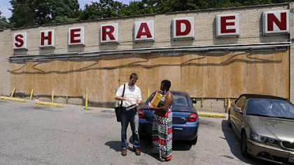 Sheraden community coordinator Steve Novotny and Tammy Thompson of NeighborWorks Western PA meet at the old supermarket in Sheraden before going door-to-door giving out information on community issues, including foreclosures and other housing concerns.