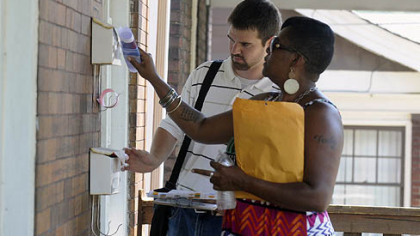 Steve Novotny, the Sheraden Community coordinator, and Tammy Thompson of NeighborWorks Western PA, go door-to-door giving out information in Sheraden on issues in the community.