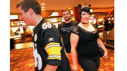 Joe Bagwell, his brother Sam Bagwell and Emily Edwards arrive for the sold out midnight theater showing of the 'Dark Knight Rises' at AMC Loews Waterfront in West Homestead.