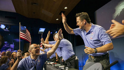 Mars Science Laboratory Curiosity team members celebrate after the successful landing of the Curiosity rover on the surface of Mars at NASA's Jet Propulsion Laboratory in Pasadena, Calif. (AP Photo/Damian Dovarganes)