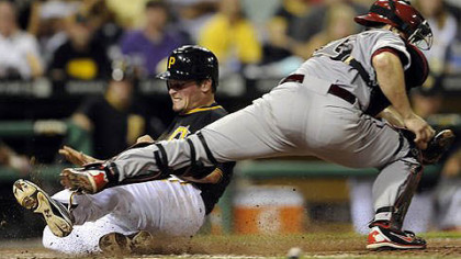 The Pirates' Travis Snyder scores the go-ahead run in the seventh inning Tuesday against the Diamondbacks.