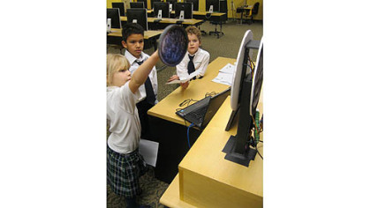 Gianna Rainone, Kadin Campeau and Connor Spratt, who will be in second grade at St. Louise de Marillac Catholic School, built a Gorgon coin that features tri-color LEDs to create glowing eyes that change from blue to red, distance sensors that recognize when someone is near and a servo that wags the monster's tongue.