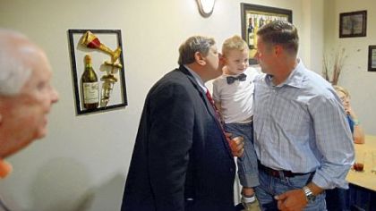 Randy Vulakovich, left, kisses his grandson Tyler Vulakovich, 2, as he is held by Mr. Vulakovich's son Randy Vulakovich Jr., right, after arriving at a campaign party Tuesday at Monte Cello's restaurant in Hampton.