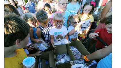 Kids select toys from a grab bag as Fawcett Plan Task Force celebrates National Night Out with food, activities, entertainment in the parking lot of the McKeesport Alliance Church parking lot.
