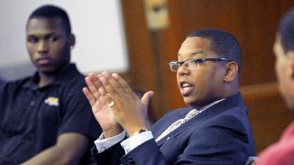 Chase Patterson, president of Corporate Diversity Associates, talks with interns at the Bar Association intern luncheon.