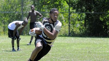 Jerome Pleasant, a senior at Imani Christian Academy, runs after catching a pass during preseason conditioning drills. Imani will play its inaugural WPIAL-sanctioned football game Aug. 31 against Bishop Canevin at Dormont Stadium.