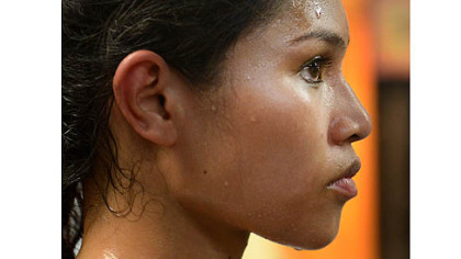 Jennifer Dugwen Chieng takes a rest during her workout Tuesday at the Third Avenue Boxing Gym in Downtown Pittsburgh.