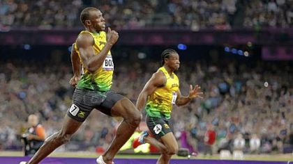 Jamaica's Usain Bolt, left, passes compatriot Yohan Blake as he races to his gold medal finish in the men's 200-meter final.