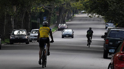 Cyclists travel along Reynolds Street, which runs between Frick Park and Mellon Park and has much less traffic than Penn Avenu.e