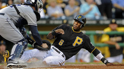 Padres' John Baker tags out Pirates' Starling Marte at home plate in the first inning Friday night at PNC Park.