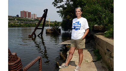 Myrna Newman, executive director of Allegheny Cleanways, stands next to the Monongahela River on Thursday at an old boat launch on the South Side.