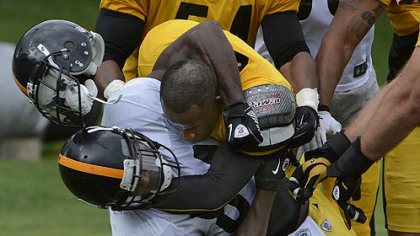 Steelers cornerback Ike Taylor, right, wrestles down wide receiver Antonio Brown. The fight started after Taylor intercepted pass and roughed up Brown in the end zone.