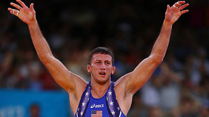 Coleman Scott stands on the podium at the medal presentation, his bronze medal around his neck.
