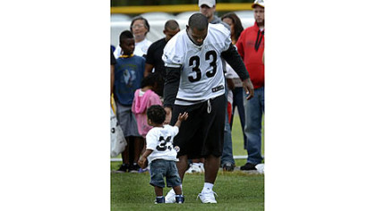 Isaac Redman spends some time with his son, Haiden, Saturday at camp at Saint Vincent College.