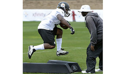 Running backs coach Kirby Wilson puts Will Johnson through his paces Saturday at Saint Vincent College in Latrobe.
