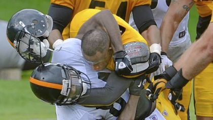 Cornerback Ike Taylor (top) wrestles down receiver Antonio Brown during a fight at training camp at Saint Vincent College in Latrobe.