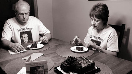 Barb and Duane DiPietro commemorate what would have been their son Justin's 27th birthday July 18 with his favorite cake, chocolate with chocolate icing, at their home in Manor, Westmoreland County.