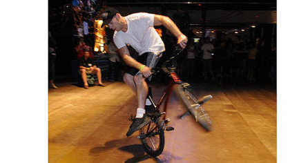 Val Naso does some tricks on a BMX bike.