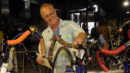Maury Burgwin puts leaflets on parked bikes.