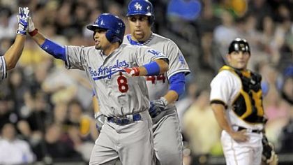 The Dodgers' Shane Victorino is congratulated at home plate after hitting a two-run home run against the Pirates in the fifth inning Monday at PNC Park.