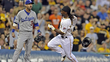 The Pirates' Andrew McCutchen scores against the Dodgers' A.J. Ellis on a double by Garrett Jones in the third inning.