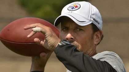 Steelers offensive coordinator Todd Haley drops back to pass during drills at training camp.