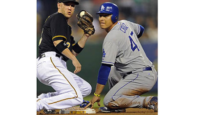 Dodgers' Luis Cruz gets into second base safely on a steal against Pirates' Clint Barmes in the third inning Tuesday night at PNC Park.