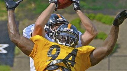 Tight end Heath Miller makes catch over top of linebacker Lawrence Timmons during workouts.