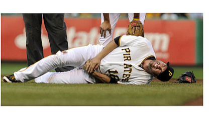 Pirates' Neil Walker writhes in pain after getting an injury to his right hand after a double play attempt on Dodgers' Mark Ellis.